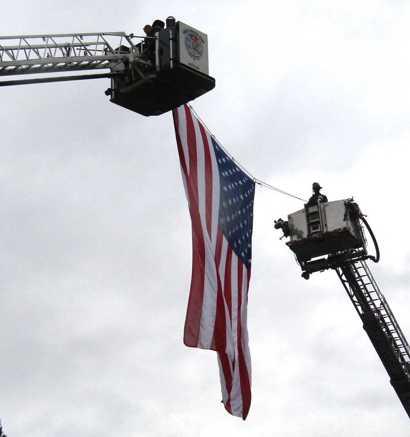 West Metro Fire hangs an American flag in the entry to the amphitheatre.